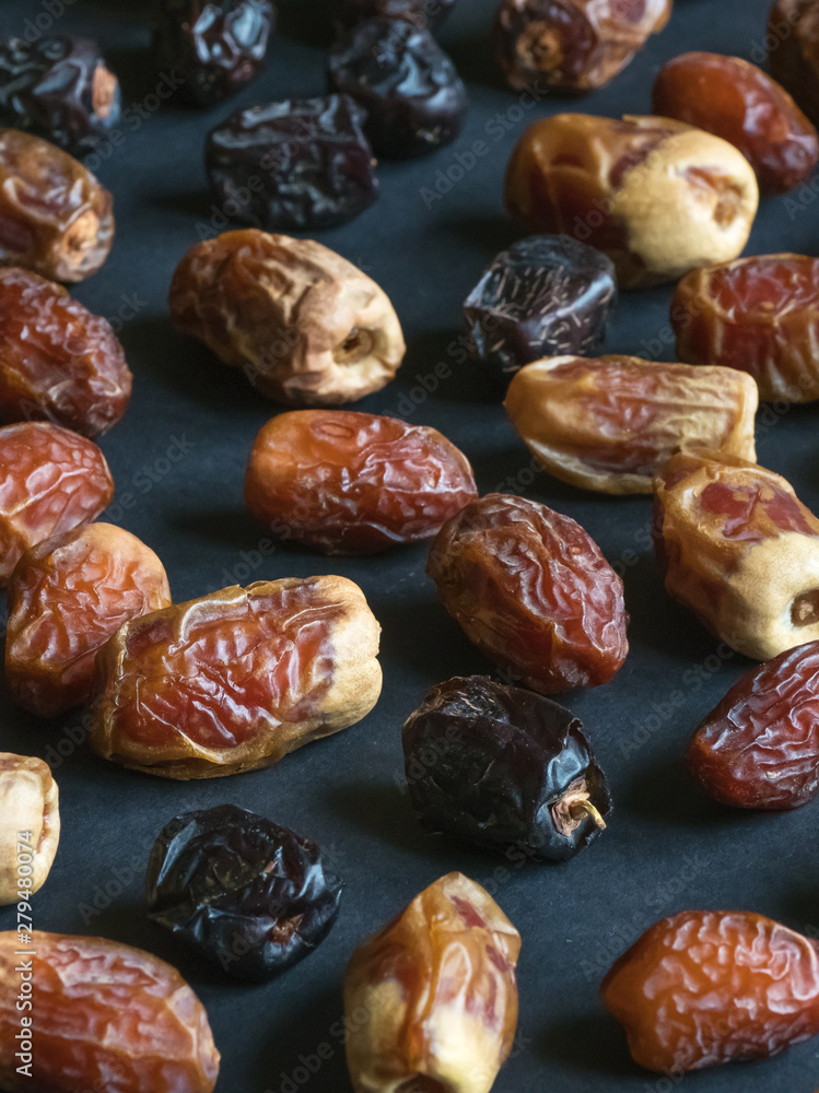 Dates are scattered on the black table Dates are scattered on the black table