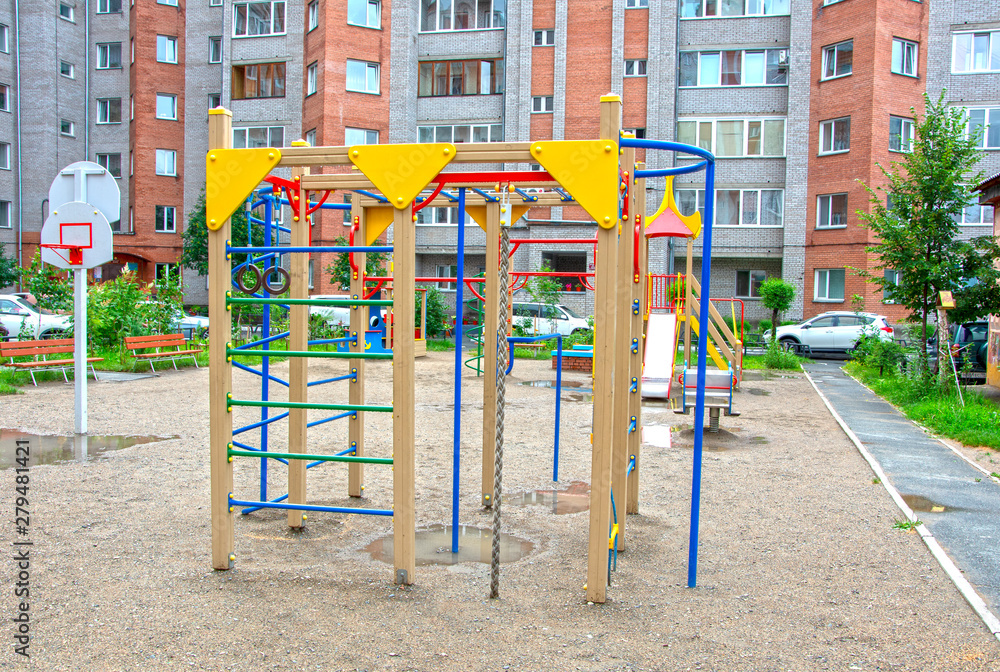 Children's playground after rain in the usual courtyard of an apartment building. provincial town. summer. Russia Children's playground after rain in the usual courtyard of an apartment building. provincial town. summer. Russia