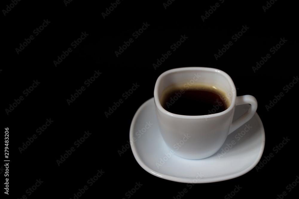 Coffee in a white cup on a dark colored background Coffee in a white cup on a dark colored background