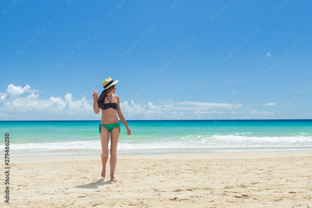 Pretty young woman, enjoying on the beach in Fuerteventura, Canary Islands, Spain.
