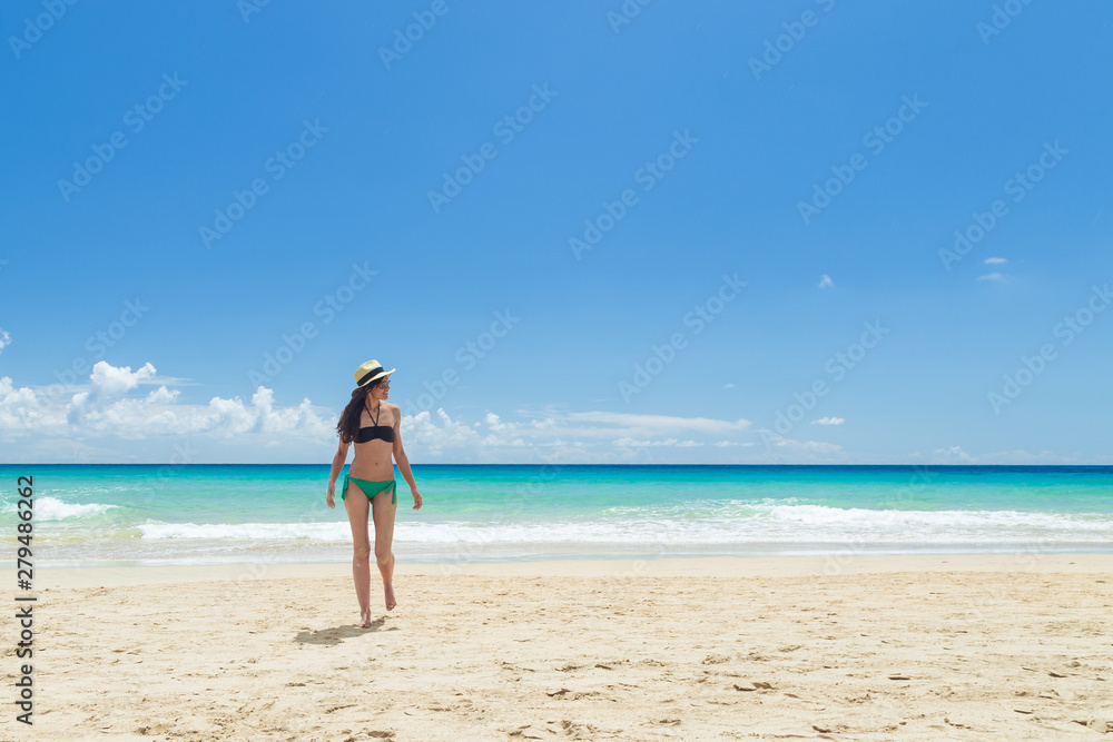 Pretty young woman, enjoying on the beach in Fuerteventura, Canary Islands, Spain.