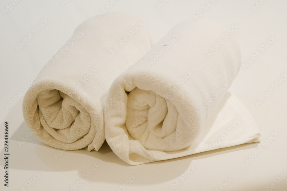 Two roll of white towel on bed Two roll of white towel on bed