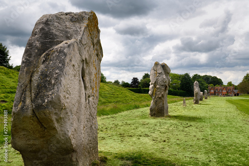 Ancient standing stones at the South West Sector of Avebury Henge with bank and ditch with Fowlers cottage Avebury Wiltshire England