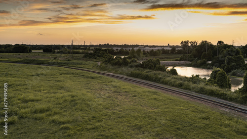 Obraz na płótnie Sunset in Sugar Land, Texas with a view of the creek and railways