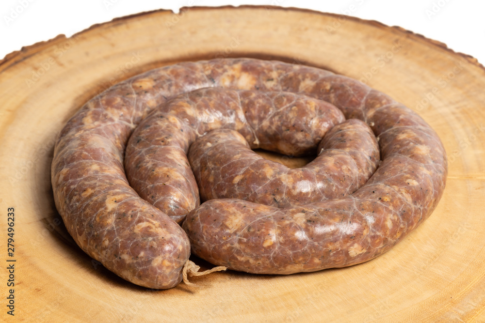 Raw homemade stuffed pork sausages isolated on a woodboard. Raw homemade stuffed pork sausages isolated on a woodboard.