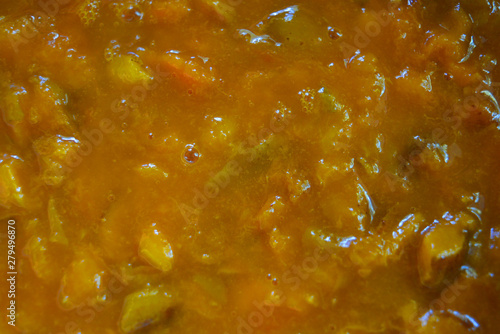 Home-made boiled jam, natural apricot and sugar jam, yellow unusual tasty background.