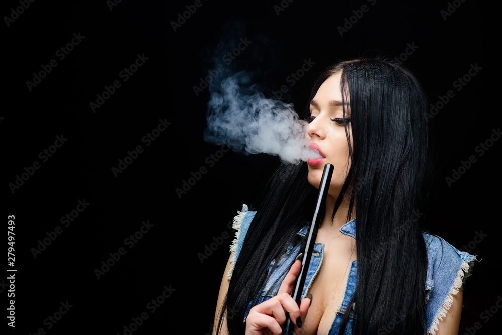 Rest and relax. Hookah bar. Electronic cigarette. Fashion girl vaping. White cloud of smoke. Vaping is sexy. Nicotine addiction. Glamorous brunette smoking vaping device black background. Girl vaping