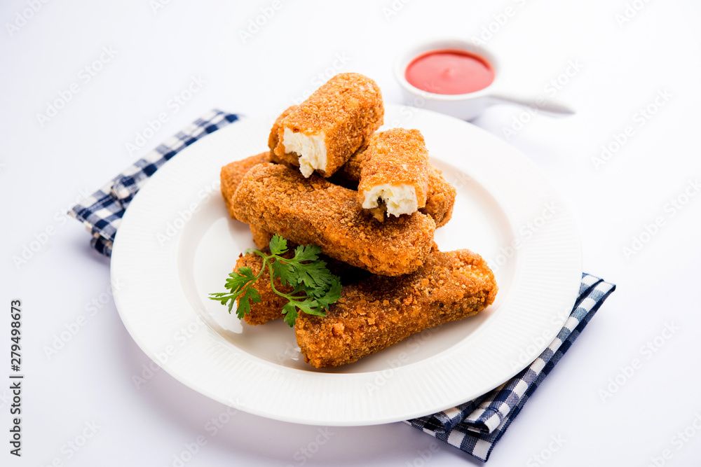 Kurkuri paneer fingers or pakora/pakoda snacks also known as Crispy Cottage Cheese Bars, served with tomato ketchup as a starter. selective focus Kurkuri paneer fingers or pakora/pakoda snacks also known as Crispy Cottage Cheese Bars, served with tomato ketchup as a starter. selective focus