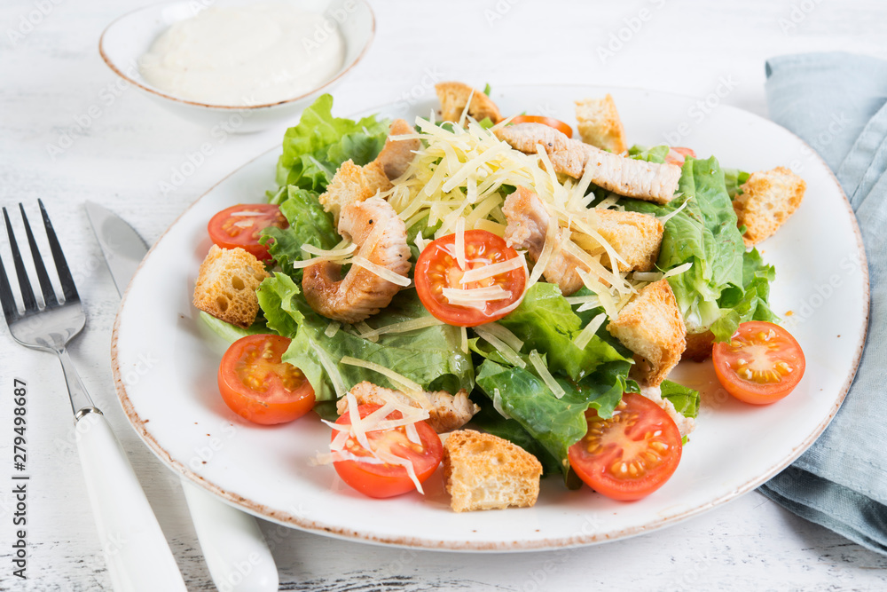 Traditional Italian Caesar salad with chicken, tomatoes and Parmesan Traditional Italian Caesar salad with chicken, tomatoes and Parmesan