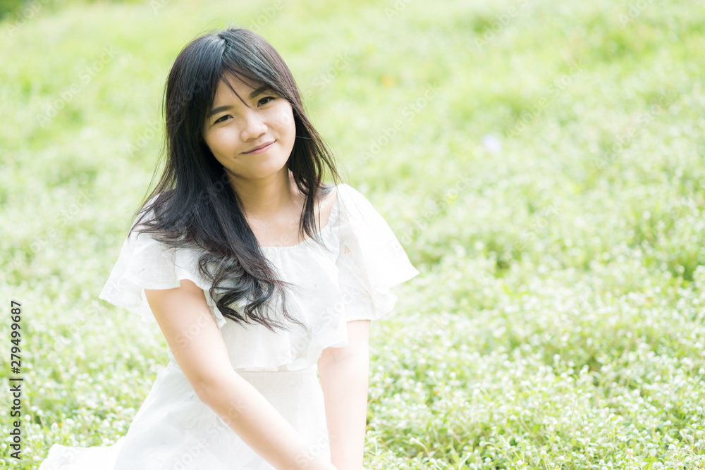 Pretty young asian fashion women relaxing in green city public park Pretty young asian fashion women relaxing in green city public park