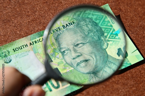 South African money concept image consisting of a magnifying glass and a 10 rand note.  photo