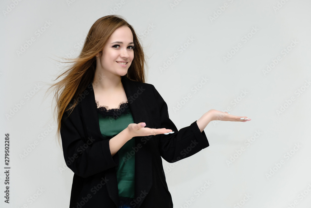 Concept portrait for the waist of a pretty girl, a young woman with long beautiful brown hair and a black jacket and blue jeans on a white background. In studio in different poses showing emotions. Concept portrait for the waist of a pretty girl, a young woman with long beautiful brown hair and a black jacket and blue jeans on a white background. In studio in different poses showing emotions.
