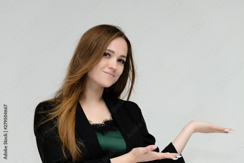 Concept close-up portrait of a pretty girl, a young woman with long beautiful brown hair and a black jacket on a white background. In the studio in different poses showing emotions. Concept close-up portrait of a pretty girl, a young woman with long beautiful brown hair and a black jacket on a white background. In the studio in different poses showing emotions.