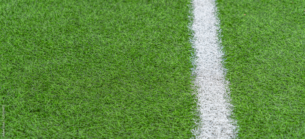 Fototapeta Green artificial grass soccer sports field with white stripe line
