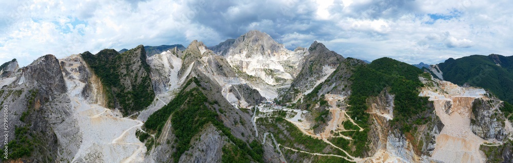 Aerial view of mountain of stone and marble quarries in the regional natural park of the Apuan Alps located in the Apennines in Tuscany, Massa Carrara Italy. Open pit mine