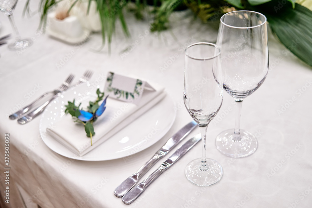 Table setting with sparcling wineglasses and cutlery on table, copy space. Menu mockup, place setting at wedding reception. Table served for wedding banquet in restauran Table setting with sparcling wineglasses and cutlery on table, copy space. Menu mockup, place setting at wedding reception. Table served for wedding banquet in restauran