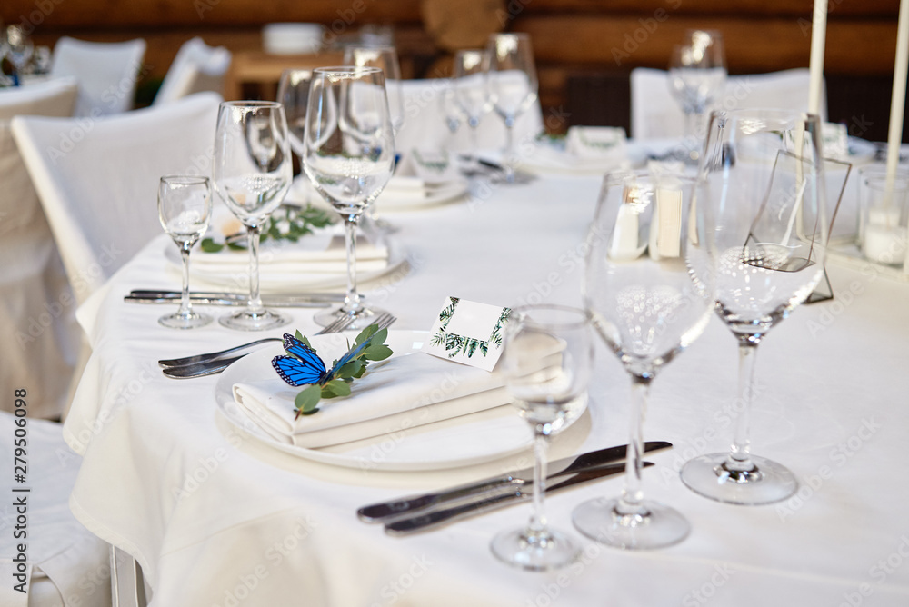 Table setting with blank guest card on empty white plate and cutlery on table, copy space. Menu mockup, place setting at wedding reception. Table served for wedding banquet in restauran Table setting with blank guest card on empty white plate and cutlery on table, copy space. Menu mockup, place setting at wedding reception. Table served for wedding banquet in restauran