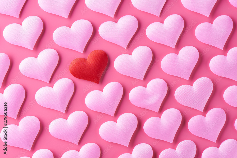Red heart on the background of many pink hearts. The concept of Valentine's Day, love, treason, polygamy