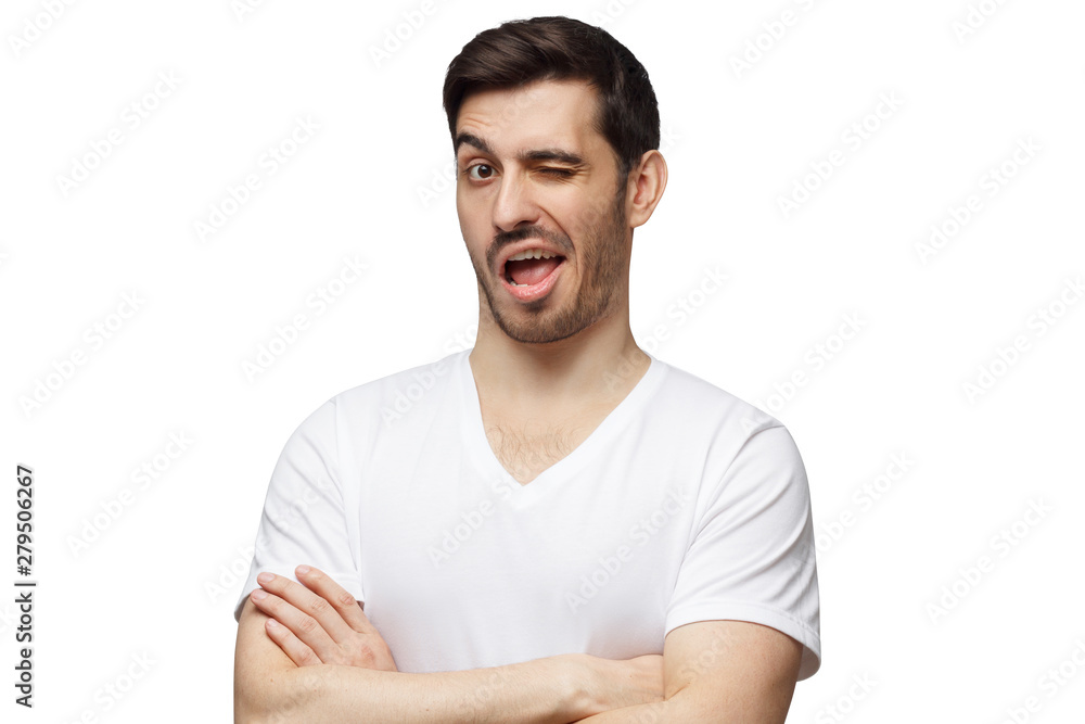 Fototapeta premium Young man winking isolated on white background