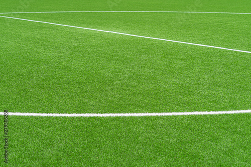 Green artificial grass soccer sports field with white stripe line © vejaa