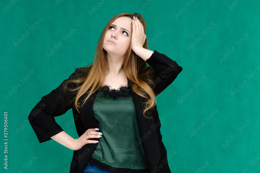 Concept portrait for a belt of a pretty girl, young woman with beautiful brown hair and in a black jacket and green T-shirt on a green background. In the studio in different poses showing emotions. Concept portrait for a belt of a pretty girl, young woman with beautiful brown hair and in a black jacket and green T-shirt on a green background. In the studio in different poses showing emotions.