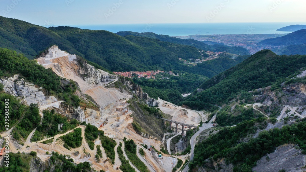 Aerial view of mountain of stone and marble quarries in the regional natural park of the Apuan Alps located in the Apennines in Tuscany, Massa Carrara Italy. Open pit mine
