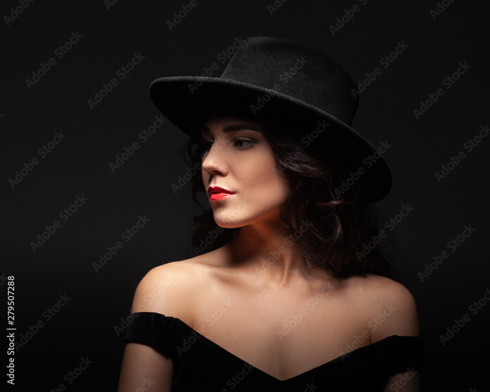 Profile portrait of a beautiful lady wearing a black hat Profile portrait of a beautiful lady wearing a black hat