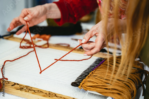 Woman demonstrating weaving and knotting