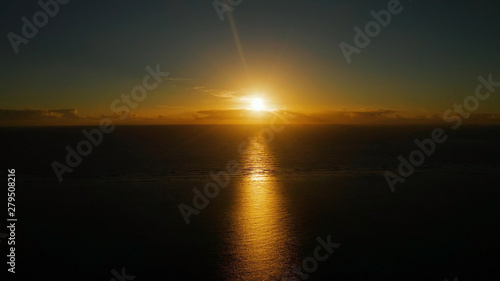 Morning sky with clouds during sunrise. Sunrise above the sea surface with waves, aerial view.Philippines. Sunrise over ocean. © Alex Traveler