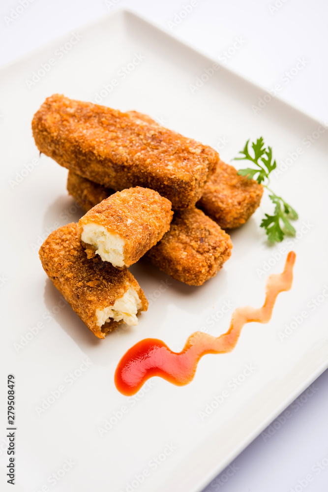 Kurkuri paneer fingers or pakora/pakoda snacks also known as Crispy Cottage Cheese Bars, served with tomato ketchup as a starter. selective focus Kurkuri paneer fingers or pakora/pakoda snacks also known as Crispy Cottage Cheese Bars, served with tomato ketchup as a starter. selective focus