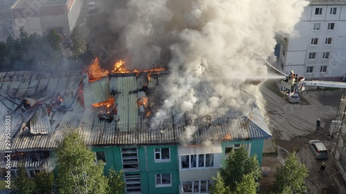 Burning roof of a residential high-rise building, clouds of smoke from the fire. top view