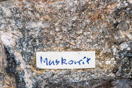 A Muskovit gemstone sparkling because of high content of metal elements label photo
