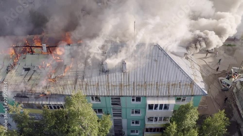 Burning roof of a residential high-rise building, clouds of smoke from the fire. top view