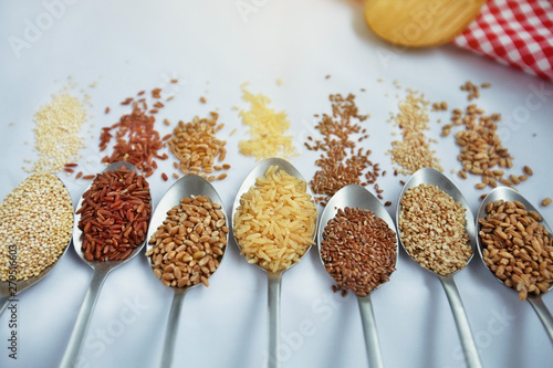 Seven spoon with grains and variations of rice with traditional italian napkin in the background