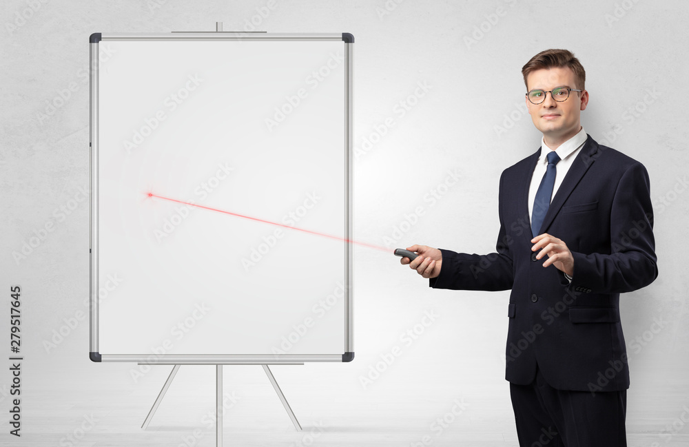Young businessman with laser pointer and copyspace white blackboard Young businessman with laser pointer and copyspace white blackboard