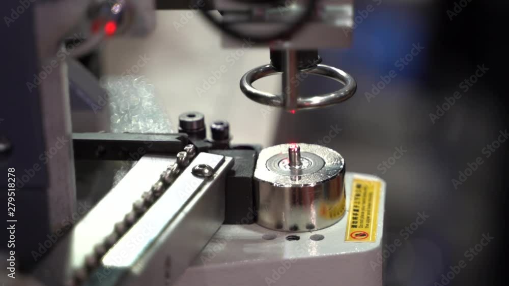 Super slow motion shot people operate automatic eyelet machine Super slow motion shot people operate automatic eyelet machine