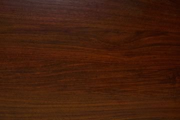 Polished wood texture. The background of polished wood texture with a dark amber color