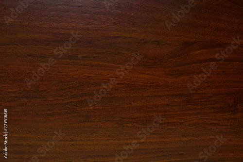 Polished wood texture. The background of polished wood texture with a dark amber color photo