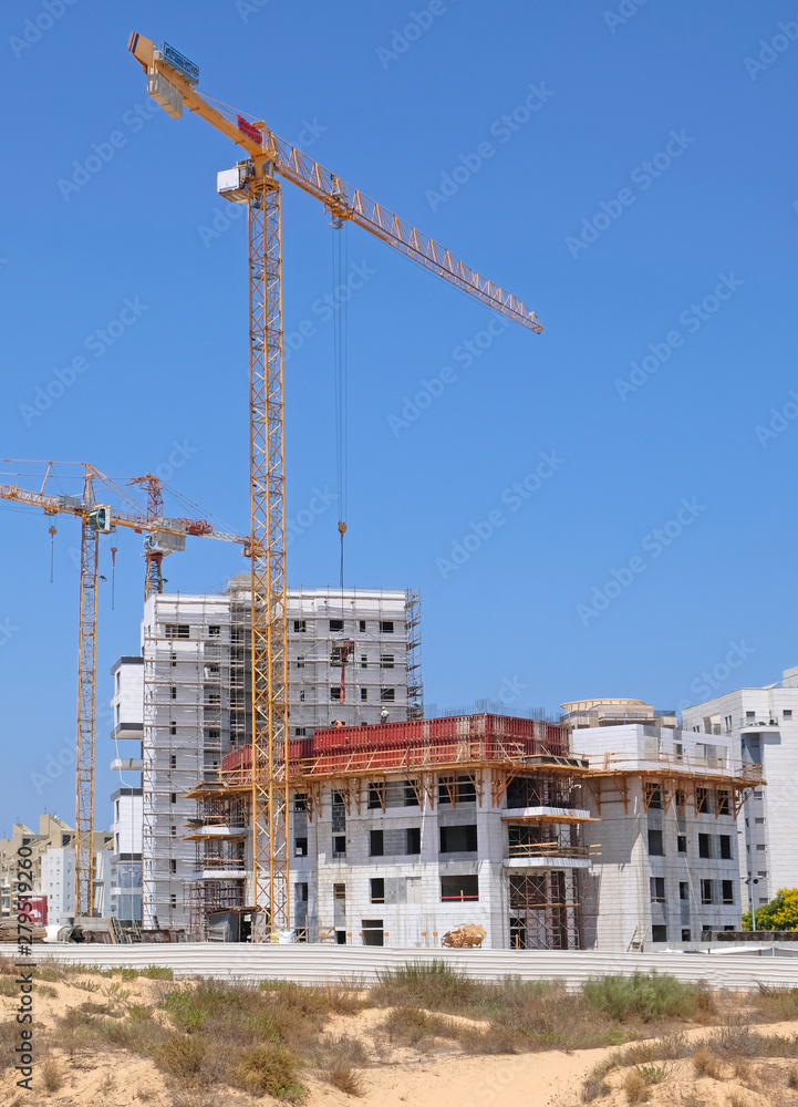 Building yard of Housing construction of houses in a new area of the city Holon in Israel Building yard of Housing construction of houses in a new area of the city Holon in Israel