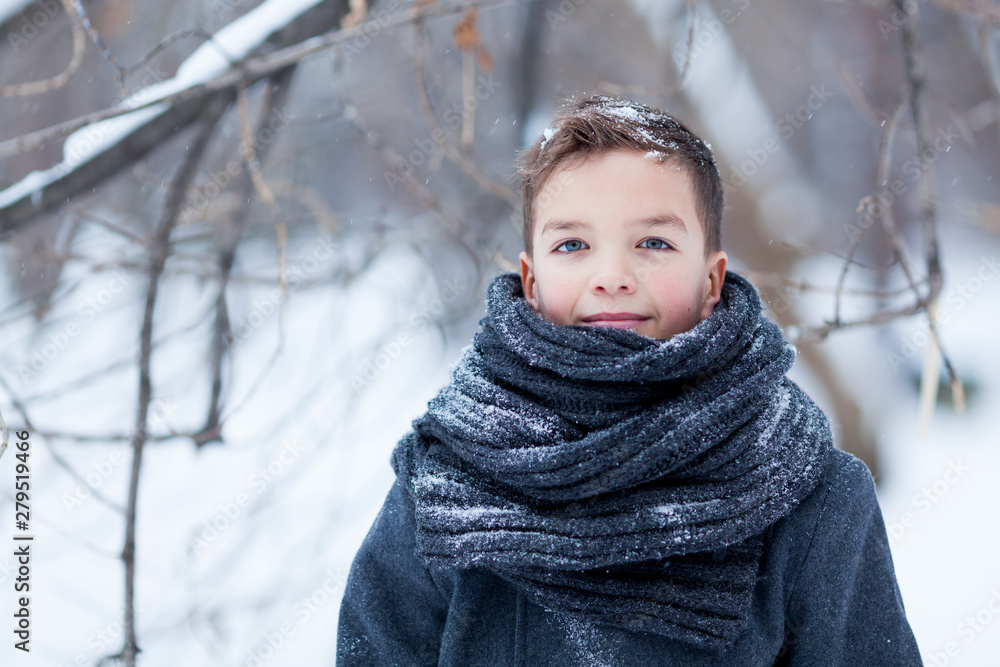 Portrait of happy boy in black coat for walk in winter park, outdoor Portrait of happy boy in black coat for walk in winter park, outdoor