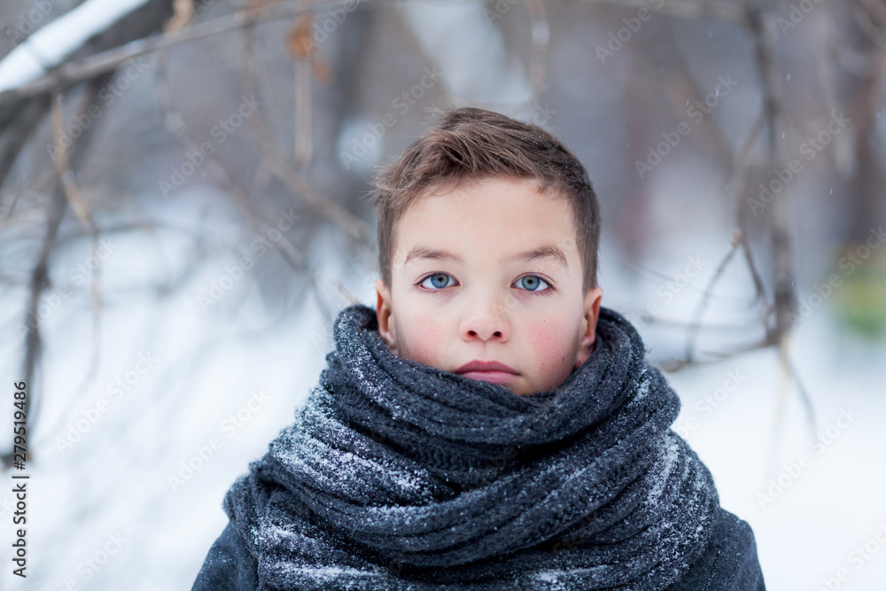 Portrait of sad boy in black coat for walk in winter park, outdoor Portrait of sad boy in black coat for walk in winter park, outdoor