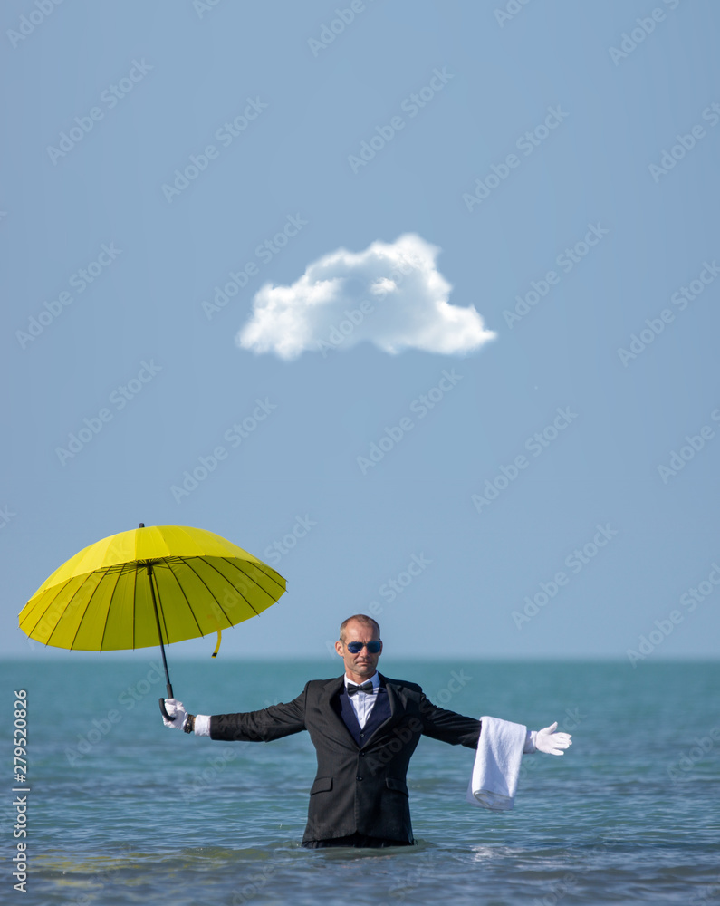 A lonely businessman with a yellow umbrella under a lonely cloud A lonely businessman with a yellow umbrella under a lonely cloud