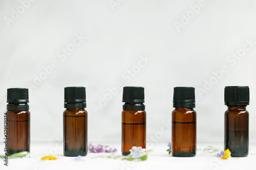 Fototapeta Naklejka Na Ścianę i Meble -  Aromatherapy plants extracts and essential oils bottles on white background