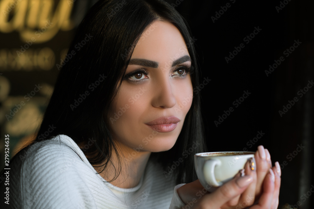 beautiful brunette with cup of coffee in cafe beautiful brunette with cup of coffee in cafe