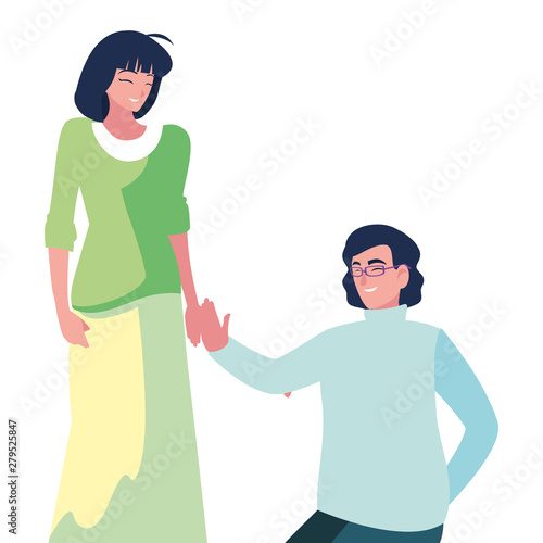 man kneeling with woman holding hand