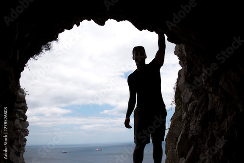 Silhouette of a man overlooking the Straight of Gibraltar from a tunnel in the Rock of Gibraltar
