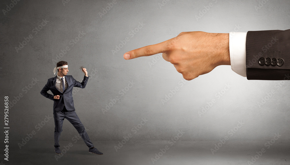 Small karate man fighting with big hand Small karate man fighting with big hand