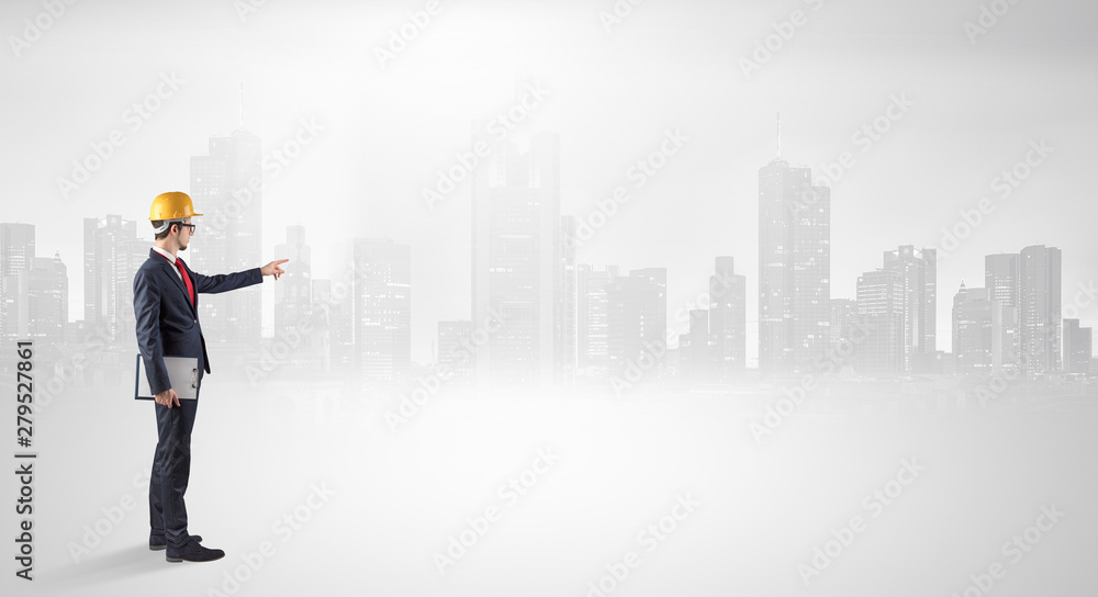 Young supervisor architect standing and looking at a big city panorama Young supervisor architect standing and looking at a big city panorama