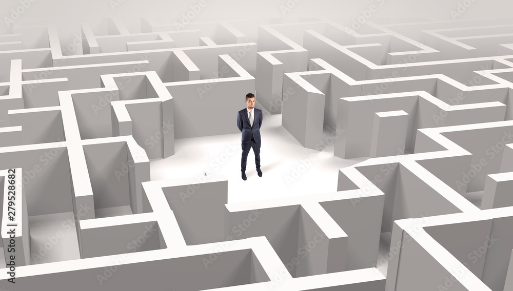 Young businessman standing in a middle of a 3D maze Young businessman standing in a middle of a 3D maze