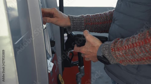 Young man pays for gas station